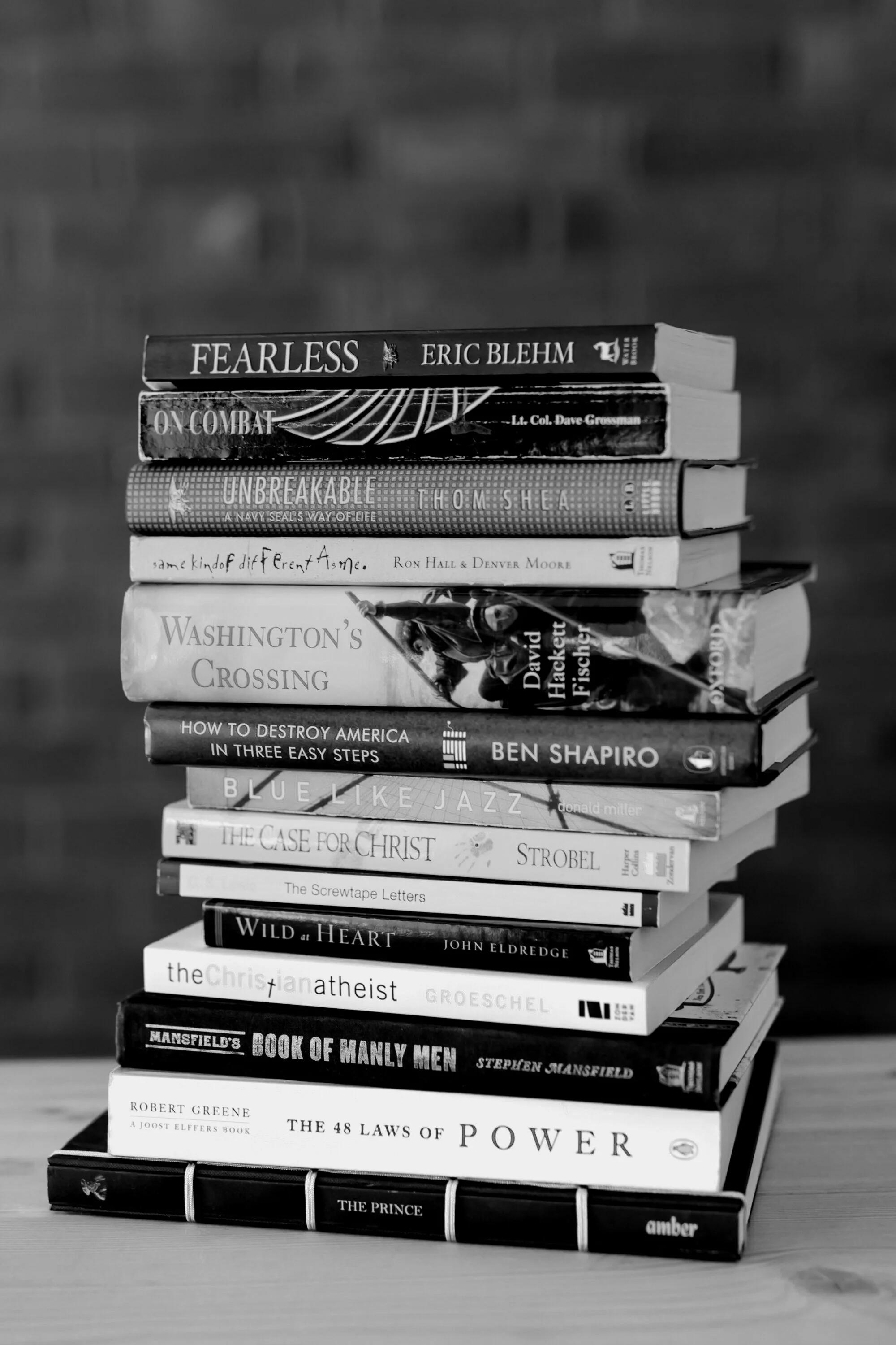 Black-and-white photo of a stack of books recommended on the show, including Fearless, Wild at Heart, and The Case for Christ
